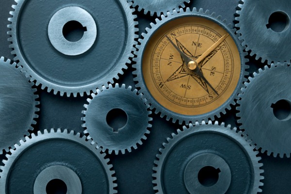 Connected Gears with Compass on Dark Background.